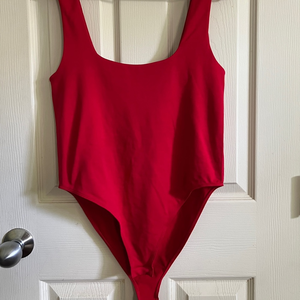 A New Day red body suit